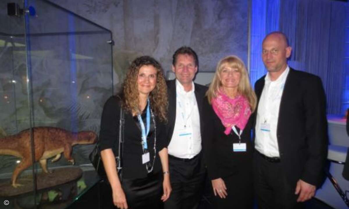 Helena Fink (EMC), Andreas Pilgrim (CNS Computer Network), Manuela Christel Schüller (Orchestra) und Stefan Soerensen (Medialine) posieren mit Dino fürs Foto