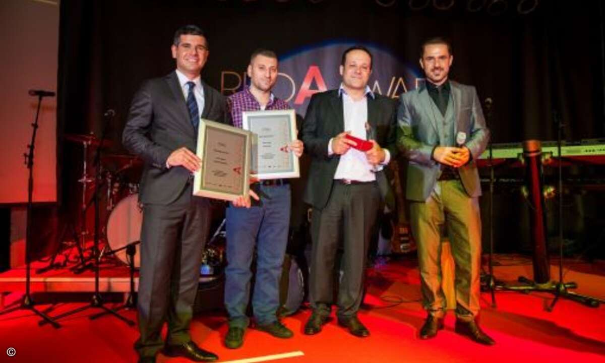Laudator Murat Ayhan (Mitte) mit den Gewinnern von der Net@Com GmbH (Bild: Einsamobile)