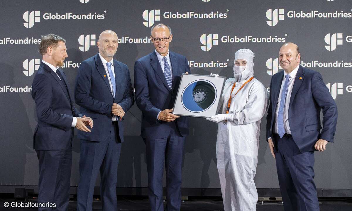 Bundeskanzler Friedrich Merz (Mitte) mit Sachsens Ministerpräsident Michael Kretschmer (links außen) und Globalfoundries-CEO Tim Breen (2.v.lks.)
